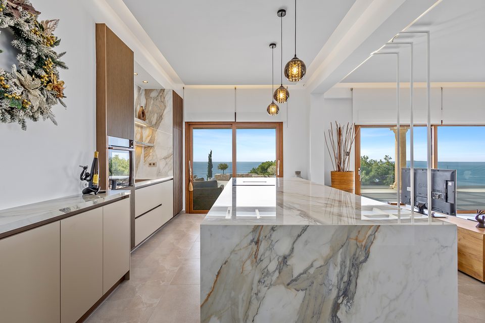 The View House kitchen island with sea horizon through the glazing