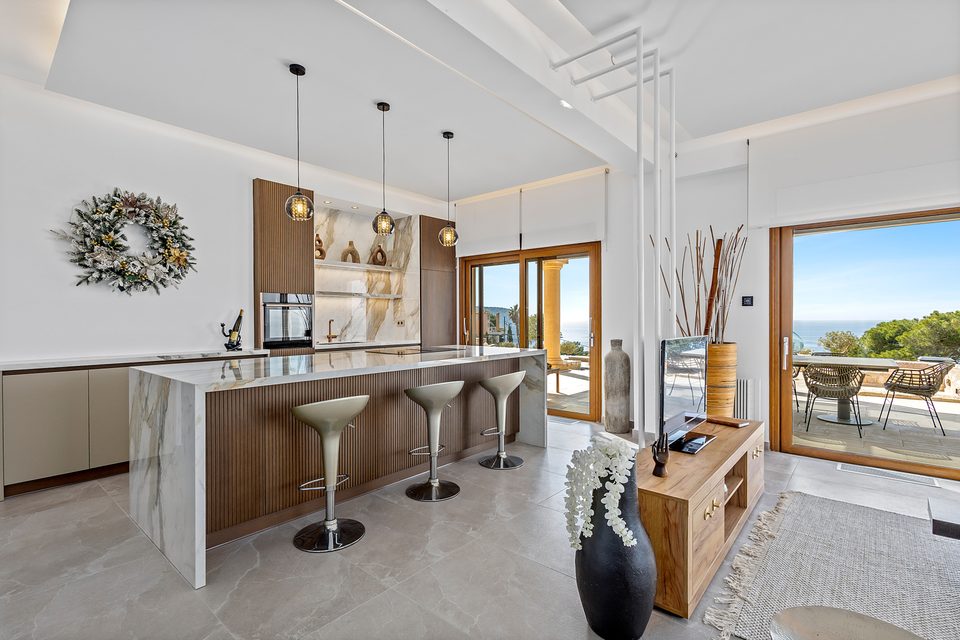 The View House marble kitchen detail opening toward the pool and sea