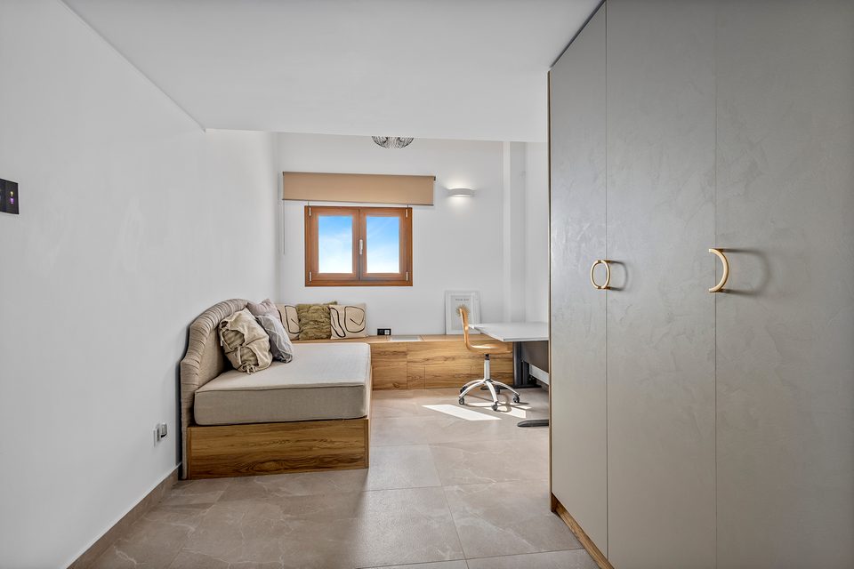 A top-floor View House corner suite with a king bed and full-width glazing onto the open gulf